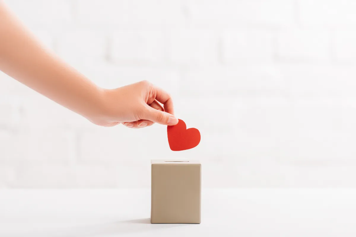 hand putting heart in box