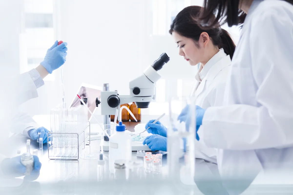 woman looking into a microscope